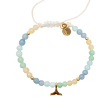 Beaded bracelet with gold charm on a white background