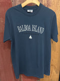 Navy blue t-shirt with 'Balboa Island, California' text on a wooden surface