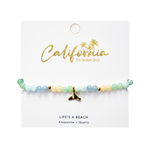 Beaded bracelet with a gold whale tail charm on a 'California' branded card.