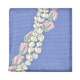 Floral lei patterned fabric on a blue background