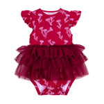 Red baby romper with floral pattern and ruffled skirt on a white background