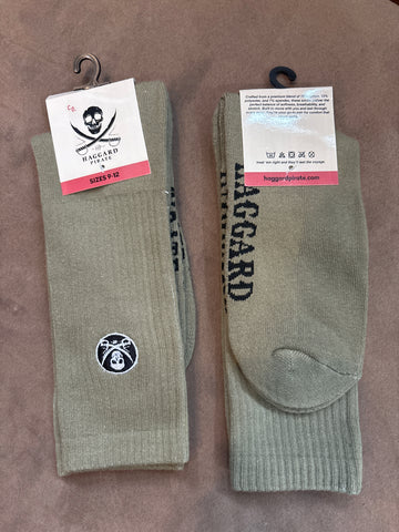 Two pairs of green socks with Haggard Pirate skull logo