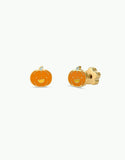 A pair of gold-toned pumpkin stud earrings with orange enamel and a carved jack-o'-lantern face, shown against a plain white background.