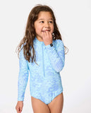 Young girl wearing a light blue patterned swimsuit on a white background