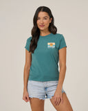 Woman wearing a teal t-shirt with a salty crew sunset logo 