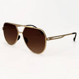 Gold-framed sunglasses with brown gradient lenses on a white background
