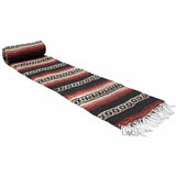 Striped woven mat with fringes on a white background