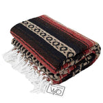 Folded woven blanket with red, black, and beige pattern