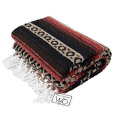 Folded woven blanket with red, black, and beige pattern