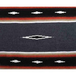 Close-up of a patterned fabric with red, white, and black colors.