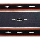 Close-up of a patterned fabric with red, white, and black colors.