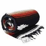 Rolled-up blanket with striped pattern and fringes