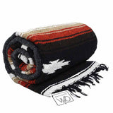 Rolled-up blanket with striped pattern and fringes