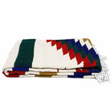 Colorful patterned blanket with fringes on a white background, featuring the brand 'West Path'