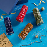 Four tiki mugs in blue, red, brown, and green.