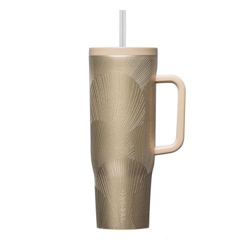 Gold-patterned mug with handle and straw on a white background