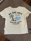 Beige colored t-shirt with a graphic print that includes text 'NO BAD DAYS' and 'NEWPORT BEACH CALIFORNIA' along with an illustration of a palm tree and a wave.