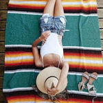 Person lying on a colorful striped towel 